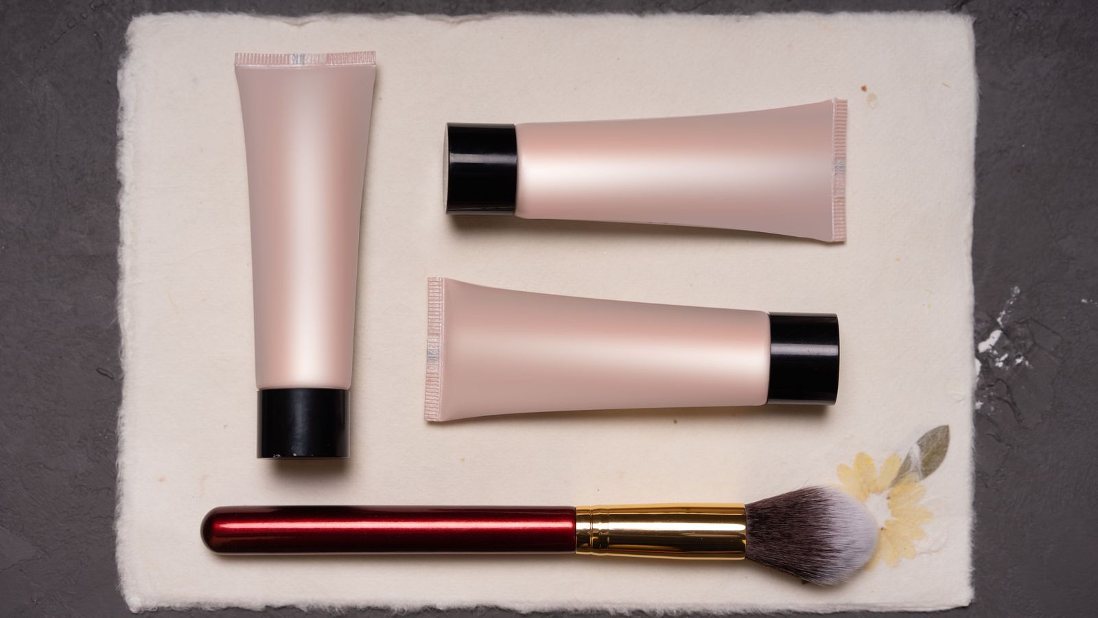 Cosmetic tubes and a makeup brush