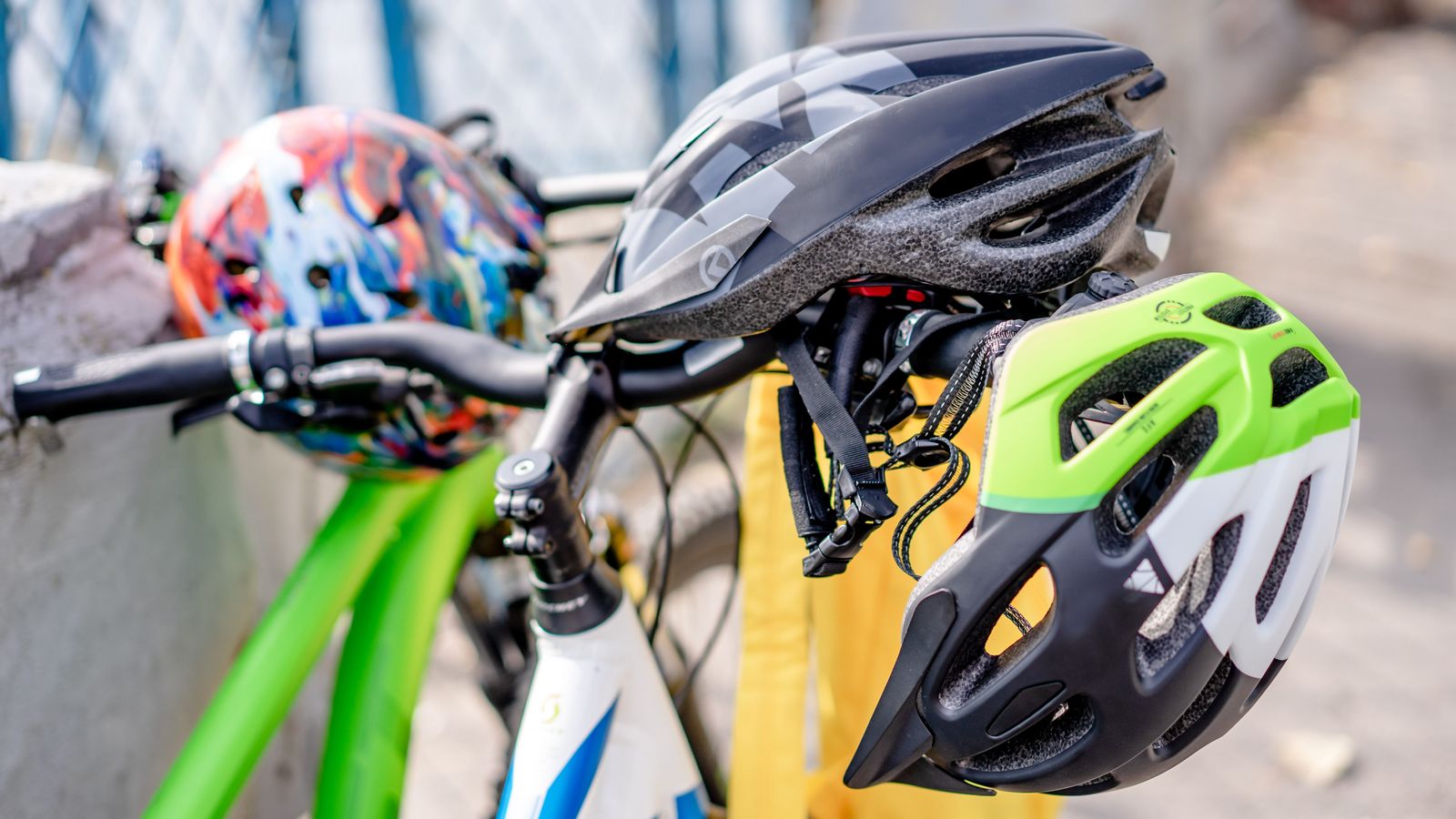Bicycle helmets hanging on a bike